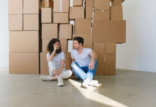 Couple preparing mentally for a move from the USA to Poland with packed boxes