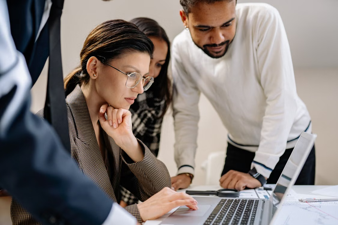 Colleagues reviewing information together on a laptop