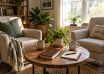 Two armchairs beside a table with mugs, a notebook and a book bearing a cross.
