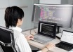 Indie game developer working with code across multiple computer screens
