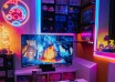 Gaming room with a television, neon wall sign and colorful RGB strip lighting
