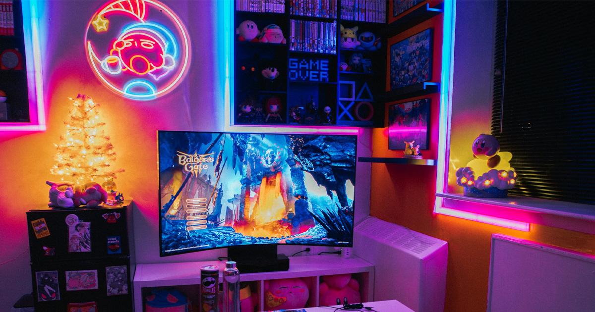 Gaming room with a television, neon wall sign and colorful RGB strip lighting