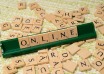 Scrabble tiles spelling ONLINE on a wooden surface