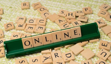 Scrabble tiles spelling ONLINE on a wooden surface