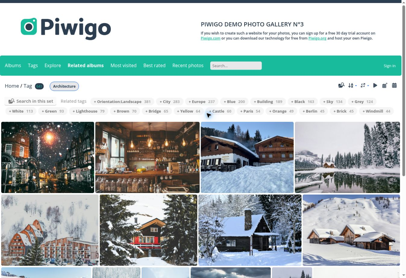 Piwigo demo gallery filtered by the Architecture tag, showing related tags and photo thumbnails.