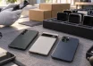 Refurbished smartphones on a testing bench beside a tray of devices prepared for business use