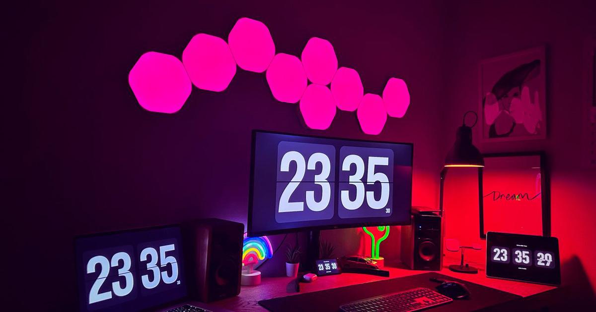 Desktop setup with pink hexagonal smart light panels above the monitor
