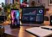 Smartphone displaying a short video beside a laptop with illustrative audience analytics.
