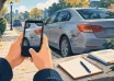 Illustration of a person photographing car accident damage with a phone beside notes and paperwork