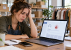 Business owner looking at a locked social media account on a laptop