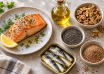 Salmon, sardines, walnuts, chia seeds, ground flaxseed and cooking oil on a kitchen table
